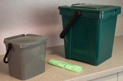 Food waste caddies on kitchen workbench