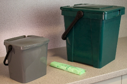 Food waste caddies on kitchen workbench