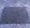 A photograph of a permanent pothole repair.
