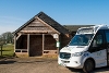 A picture of the Community Connect Northwest Downlands Bus at Brightwalton Village Hall bus stop.