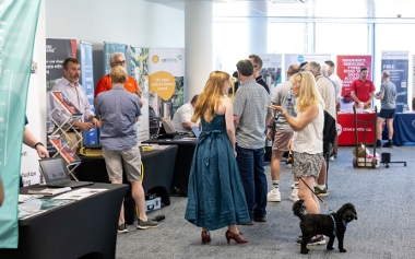 Indoor stands, visitors, and a cute dog!