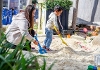 Image of a child and Nursery worker playing in a sandpit at Victoria Park School, Newbury
