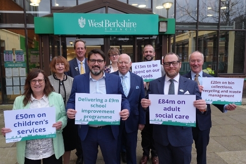 Members of the Executive holding signs